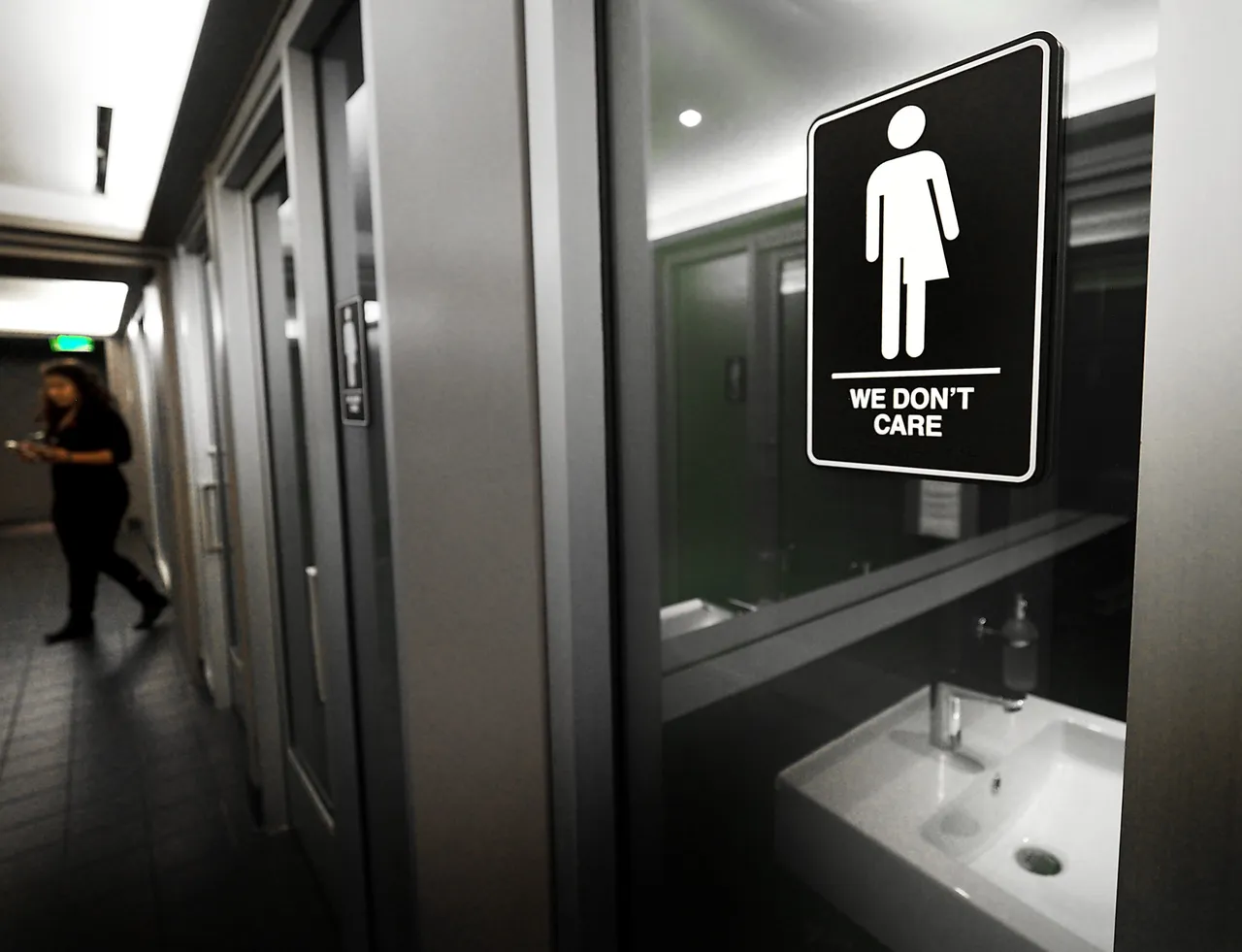 Gender neutral signs are posted in the 21C Museum Hotel public restrooms on May 10, 2016 in Durham, North Carolina.