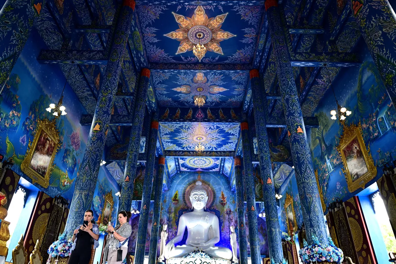 TOPSHOT - Tourists visit the Wat Rong Suea Ten Buddhist temple, popularly known as "Blue Temple," in northern Thailand's Chiang Rai province on May 26, 2025. (Photo by MANAN VATSYAYANA/AFP via Getty Images)