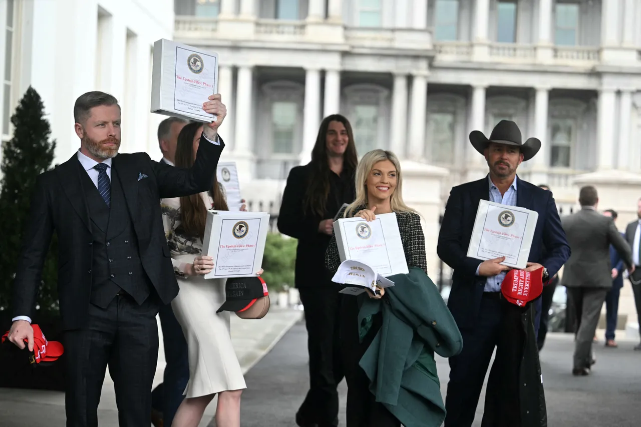 (From L) Political commentator Rogan O'Handley, aka DC Draino, TikToker Chaya Raichik, US conservative activist Scott Presler, commentator Liz Wheeler and US conservative political commentator Chad Prather carry binders bearing the seal of the US Justice Department reading "The Epstein Files: Phase 1" as they walk out of the West Wing of the White House in Washington, DC, on February 27, 2025. The Trump administration has said it would release documents on late tycoon and convicted sex trafficker Jeffrey Epstein who was found dead in his prison cell in 2019. (Photo by Jim WATSON / AFP) (Photo by JIM WATSON/AFP via Getty Images)