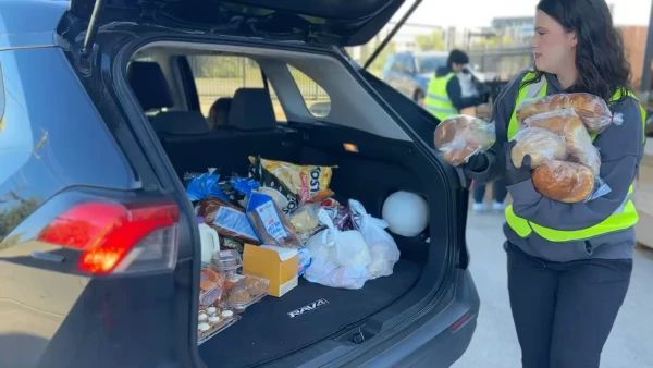 Volunteers load food into a car at a drive-through distribution site in Houston. Credit: Photo courtesy of Catholic Charities of the Archdiocese of Galveston-Houston