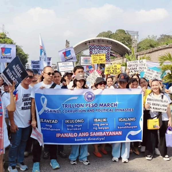 Protesters hold signs and banners during a rally against corruption at the EDSA People Power Monument in Manila on Sunday, Nov. 30, 2025. Credit: Santosh Digal