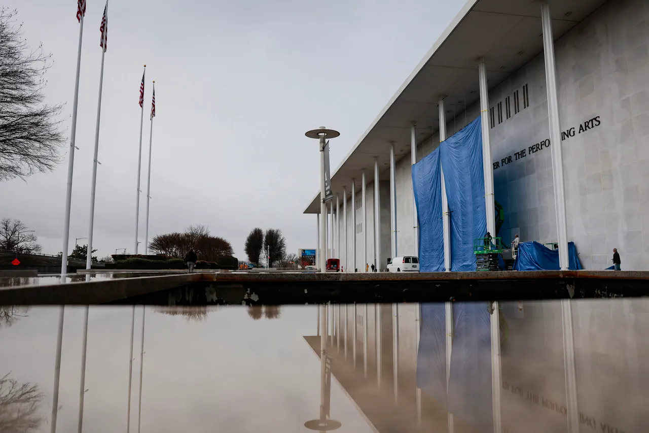 WASHINGTON, DC - DECEMBER 19: Workers begin adjusting the name of the “John F. Kennedy Memorial Center for the Performing Arts