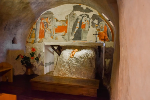 The Grotto of the Nativity inside the sanctuary of Greccio (Italy). It is a small and simple room. Beneath the altar table is the recess in the rock that, according to tradition, housed the statue of the baby Jesus that miraculously came to life during the reenactment directed by St. Francis. Credit: Marinella Bandini