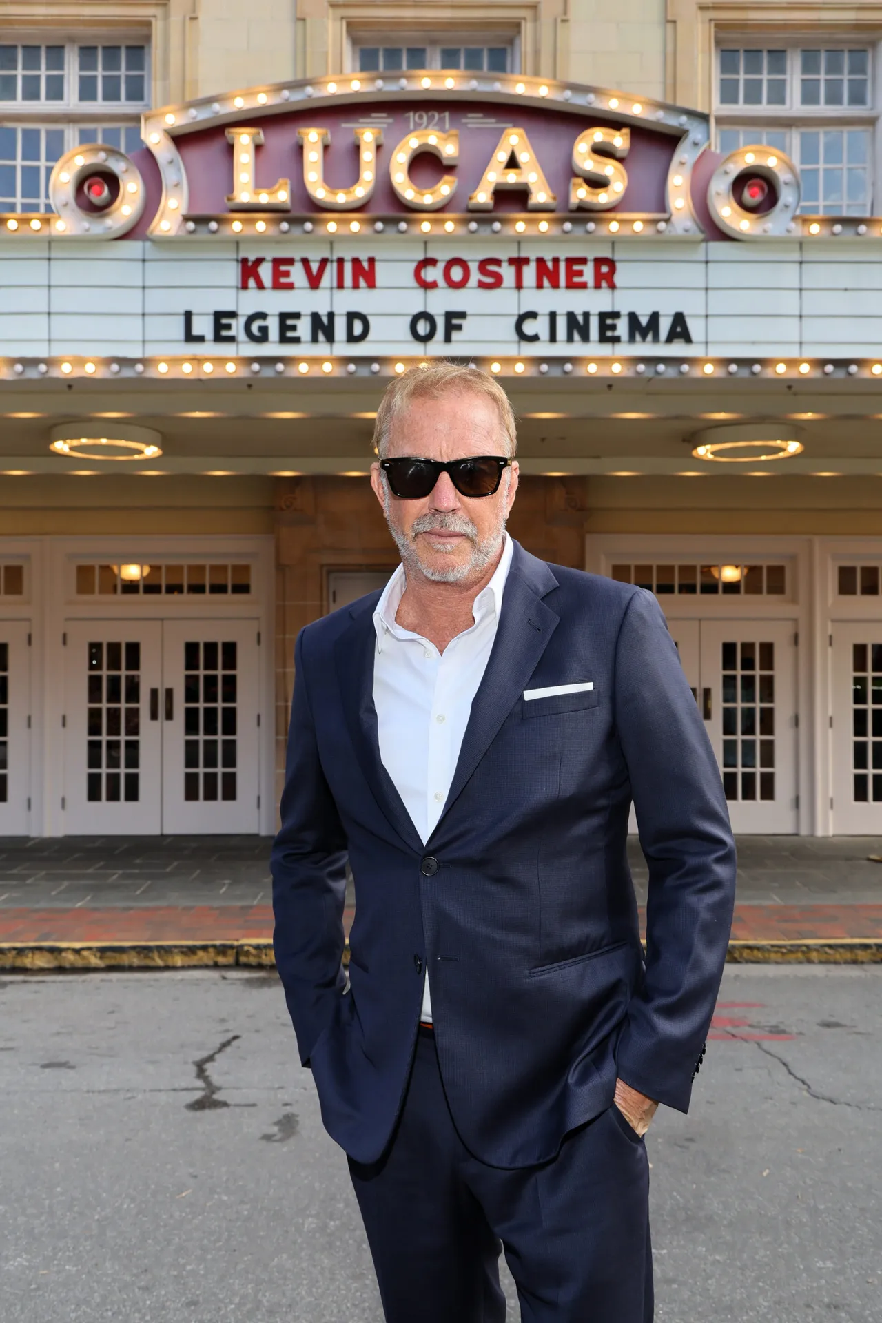 SAVANNAH, GEORGIA - NOVEMBER 01: Kevin Costner poses in front of the marquee ahead of a screening of 