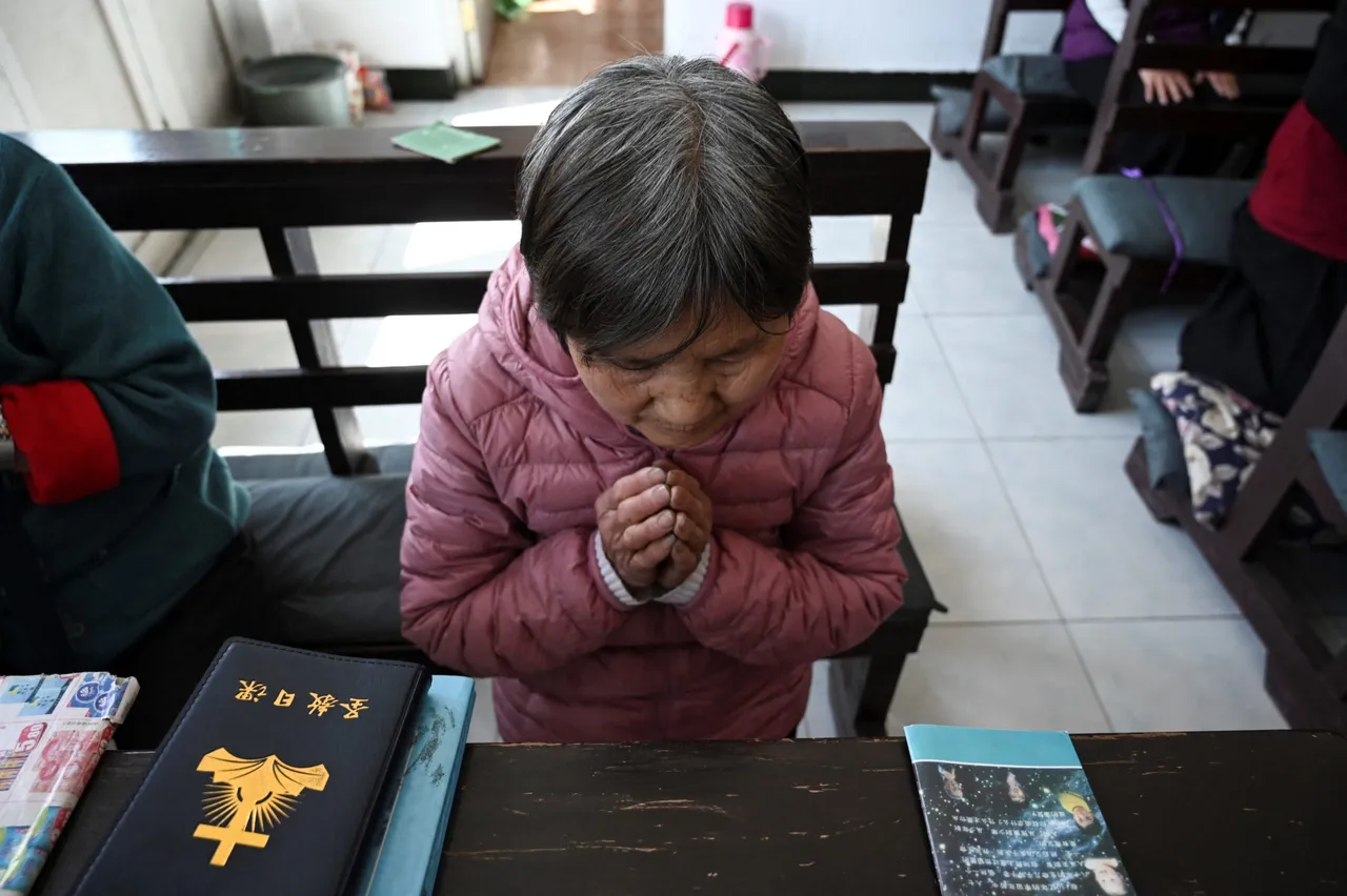 A Catholic worshipper prays during an Easter Sunday mass at a prayer house in a village near Beijing on April 4, 2021. (Photo by JADE GAO/AFP via Getty Images)