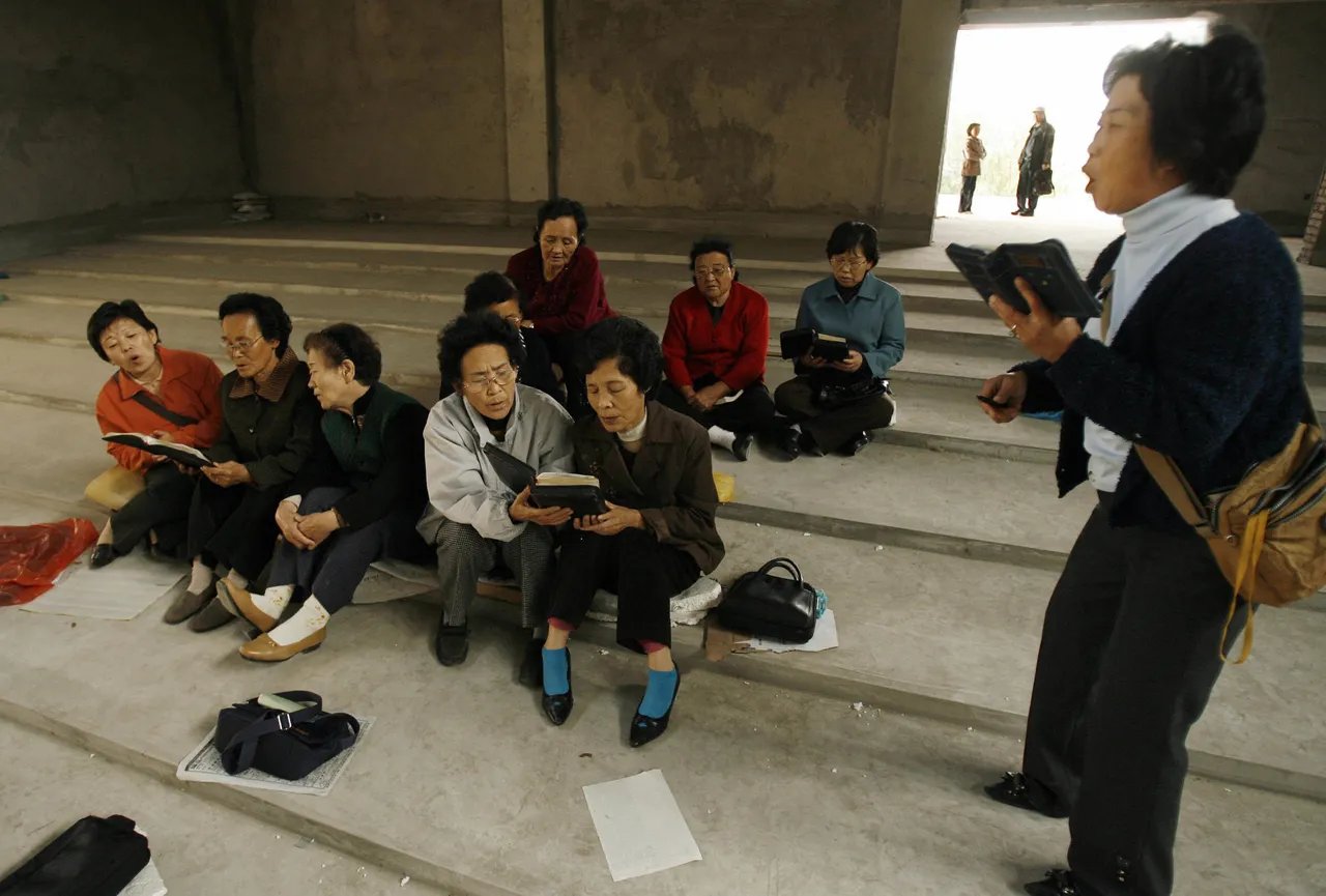 Yanji, CHINA: Ethnic Korean christians sing hymns in their half-finished church in the town of Yanji in Yanbian Korean Autonomous Prefecture on the China/North Korea border, 13 October 2006. For North Korean refugees, Yanbian's Christian groups are crucial in providing shelter and aid, both from state-approved and unsanctioned "underground" churches with up to 300,000 North Korean refugees believed to live illegally in the Yanbian region of Jilin province, many of whom risked torture, jailings or execution to escape starvation and oppression in their homeland. (Photo credit PETER PARKS/AFP via Getty Images)