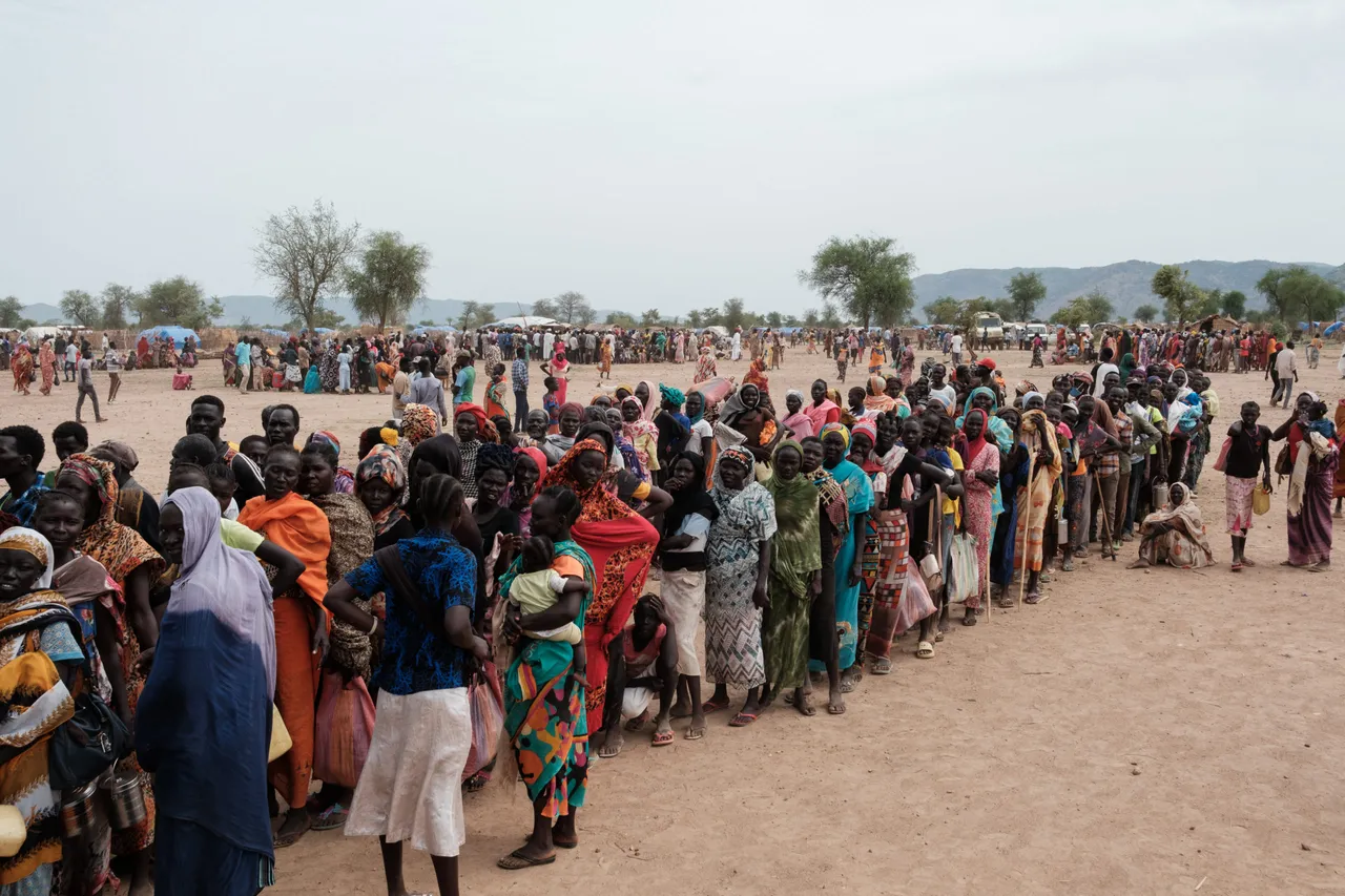 People line up to register for a potential food aid delivery at a camp for internally displaced persons (IDP) in Agari, South Kordofan, on June 17, 2024. (Photo by GUY PETERSON/AFP via Getty Images)