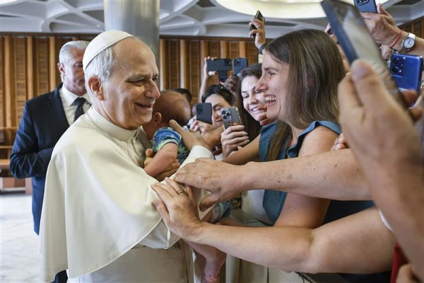 Pope Leo ambraces a baby at his general audience on Aug. 27, 2025. Credit: Vatican Media