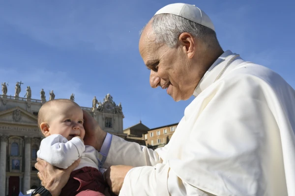 Pope Leo blesses a baby on All Saints' Day 2025. Credit: Vatican Media