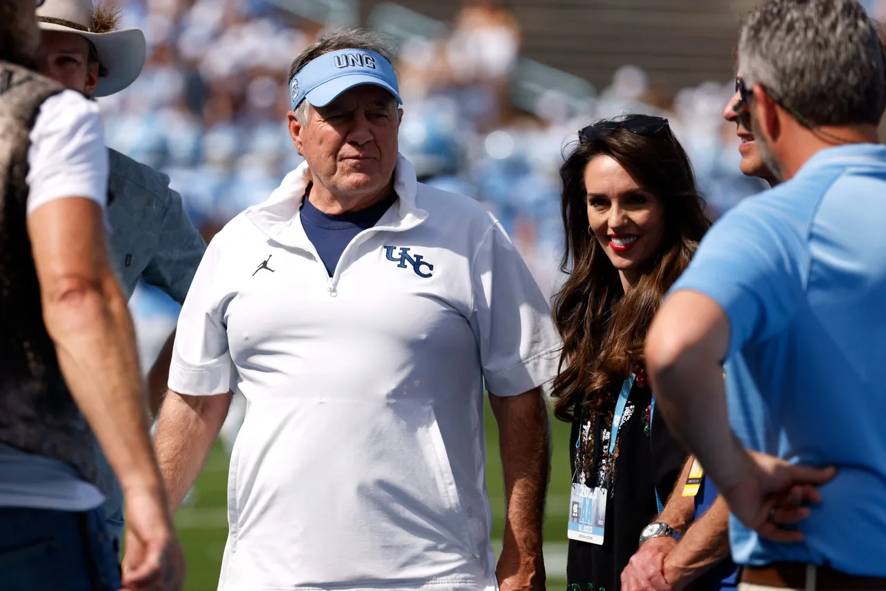 CHAPEL HILL, NORTH CAROLINA - SEPTEMBER 13: Head coach Bill Belichick of the North Carolina Tar Heels and Jordon Hudson look on prior to the game against the Richmond Spiders at Kenan Memorial Stadium on September 13, 2025 in Chapel Hill, North Carolina. (Photo by Lance King/Getty Images)