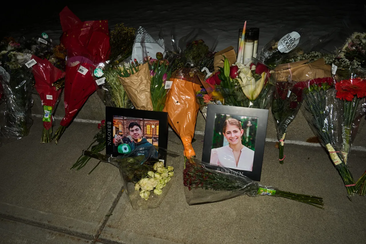 Framed photos of mass shooting victims Mukhammad Aziz Amurzokov and Ella Cook are seen at a makeshift memorial near Brown University in Providence, Rhode Island, on December 15, 2025. A gunman remained at large after a weekend mass shooting at elite Brown University left two dead and nine wounded, with US authorities releasing new footage of a masked 