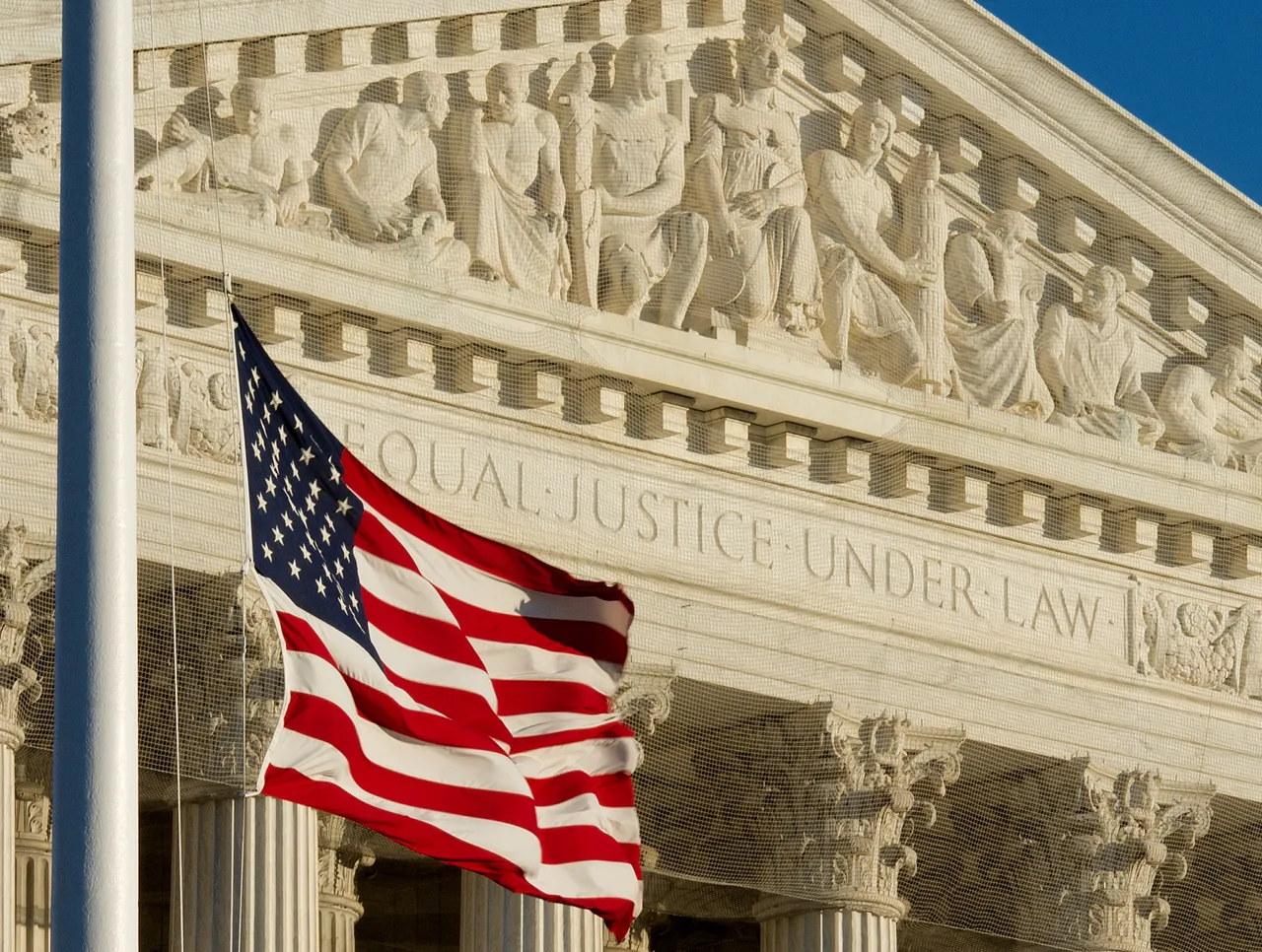 The US flag flies at half-staff outside the US Supreme Court on January 9, 2011 (Photo by PAUL J. RICHARDS/AFP via Getty Images)