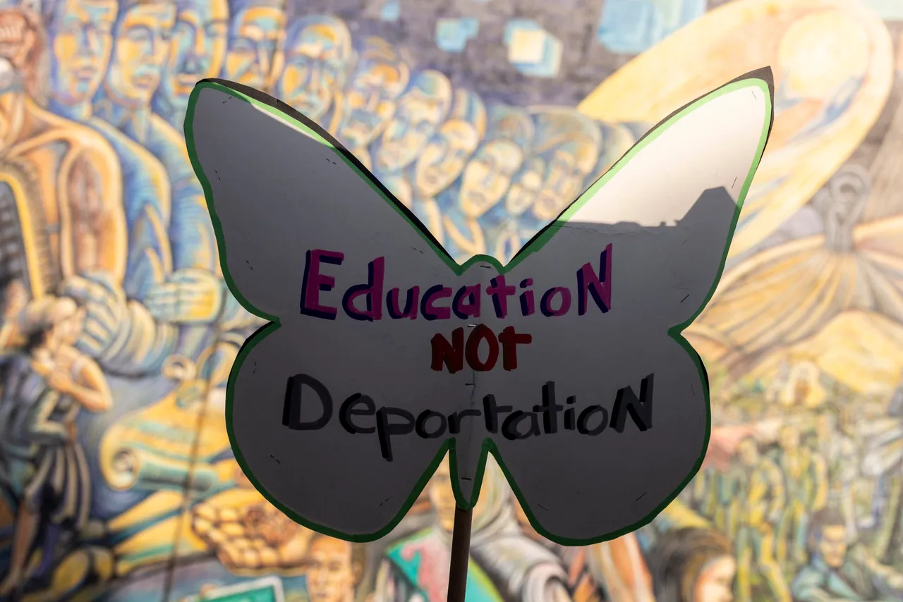 A demonstrator holds up a sign during a press conference and rally at Salazar Park, in Boyle Heights, east of Los Angeles, California, on June 11, 2025