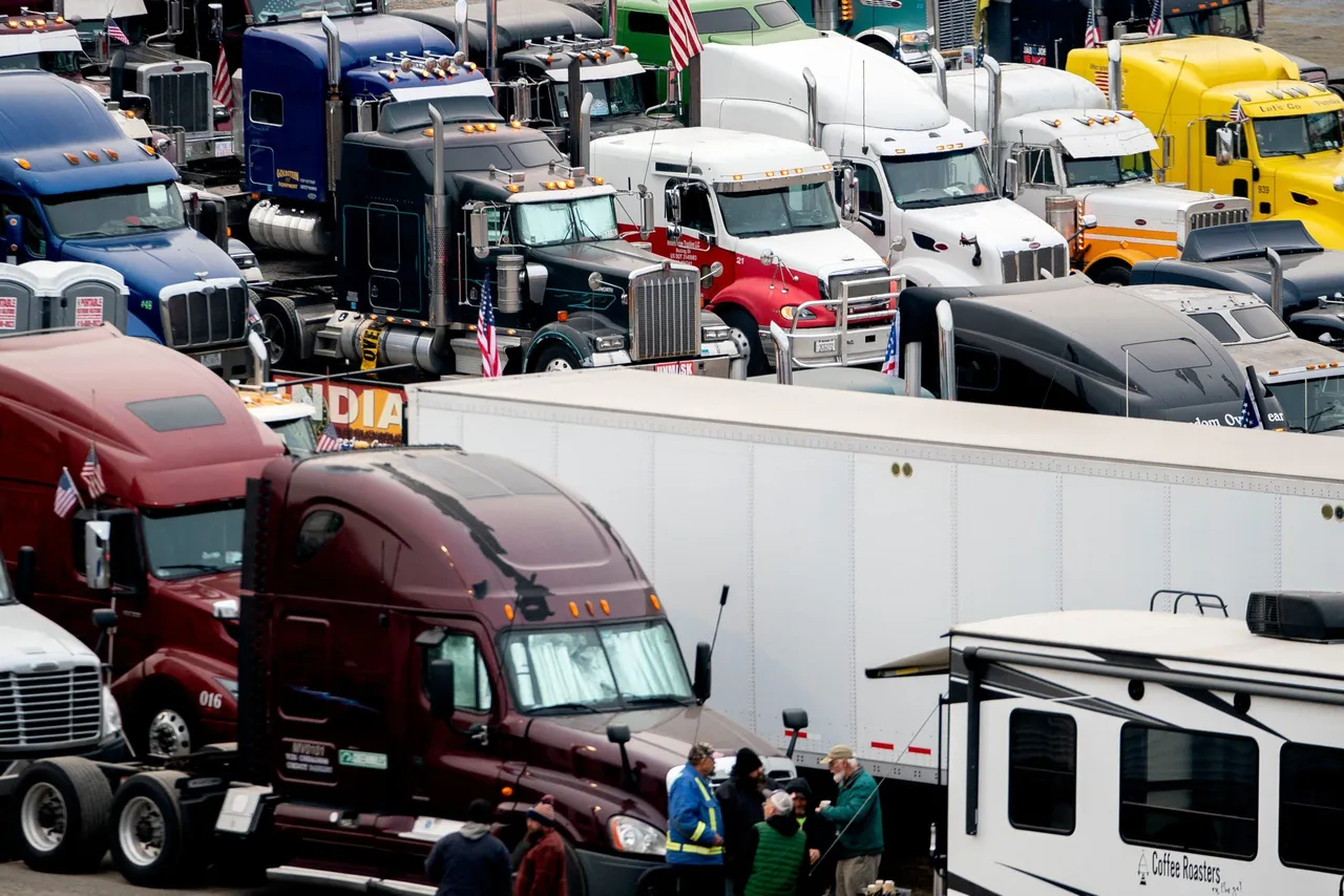 Trucks belonging to participants of the Peoples Convoy sit at Hagerstown Speedway. (Photo by STEFANI REYNOLDS/AFP via Getty Images)