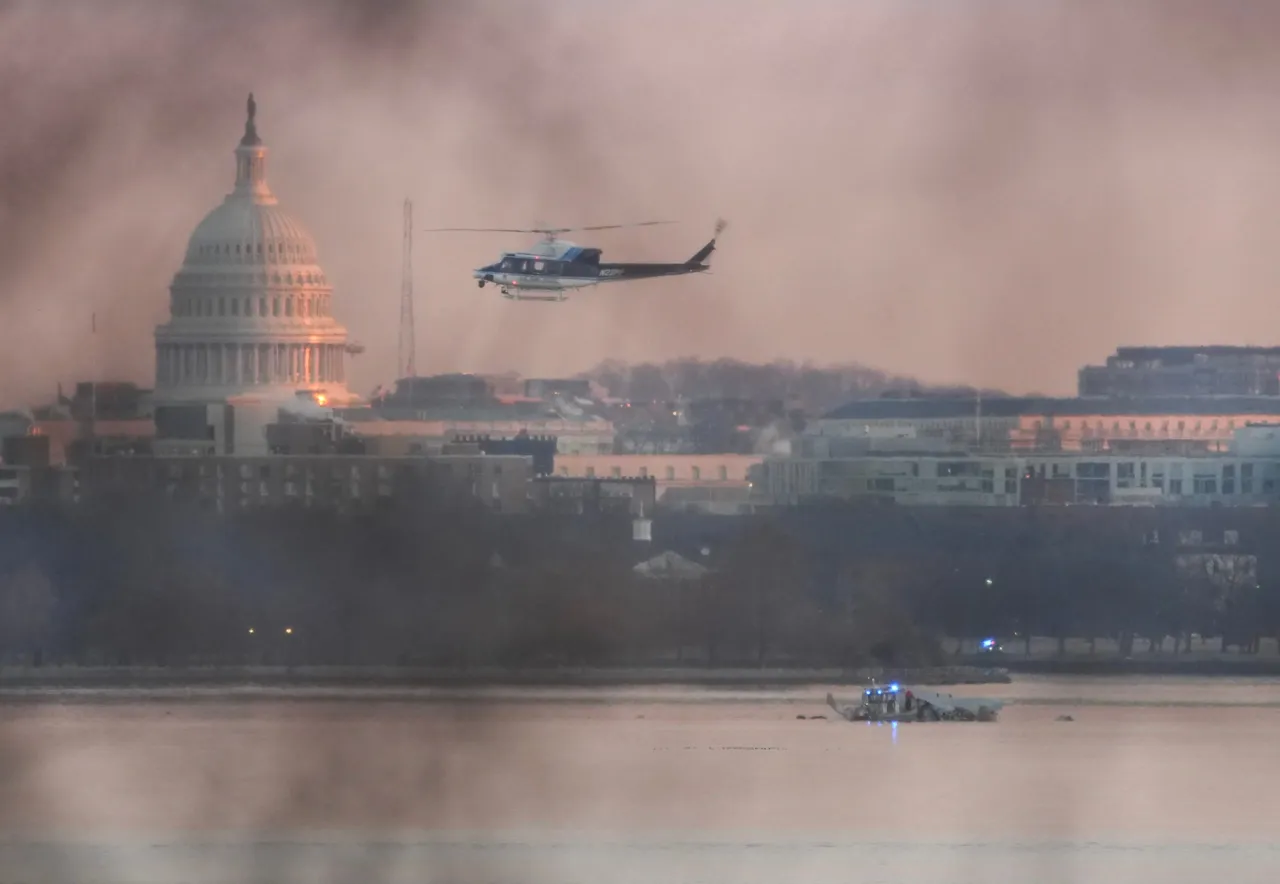 ARLINGTON, VIRGINIA - JANUARY 30: A helicopter flies near the crash site of the American Airlines plane on the Potomac River after the plane crashed on approach to Reagan National Airport on January 30, 2025 in Arlington, Virginia. The American Airlines flight from Wichita, Kansas collided with a military helicopter while approaching Ronald Reagan National Airport. Dozens of people are feared to have died in the midair collision. (Photo by Andrew Harnik/Getty Images)