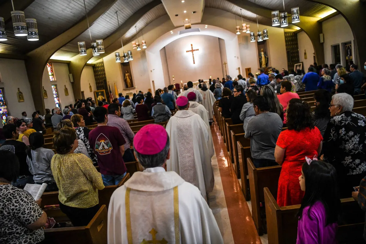 People gather at the Sacred Heart Catholic Church to pray for the victims of the mass shooting at Robb Elementary School in Uvalde, Texas on May 25, 2022. - The tight-knit Latino community of Uvalde was wracked with grief Wednesday after a teen in body armor marched into the school and killed 19 children and two teachers, in the latest spasm of deadly gun violence in the US. (Photo by CHANDAN KHANNA/AFP via Getty Images)