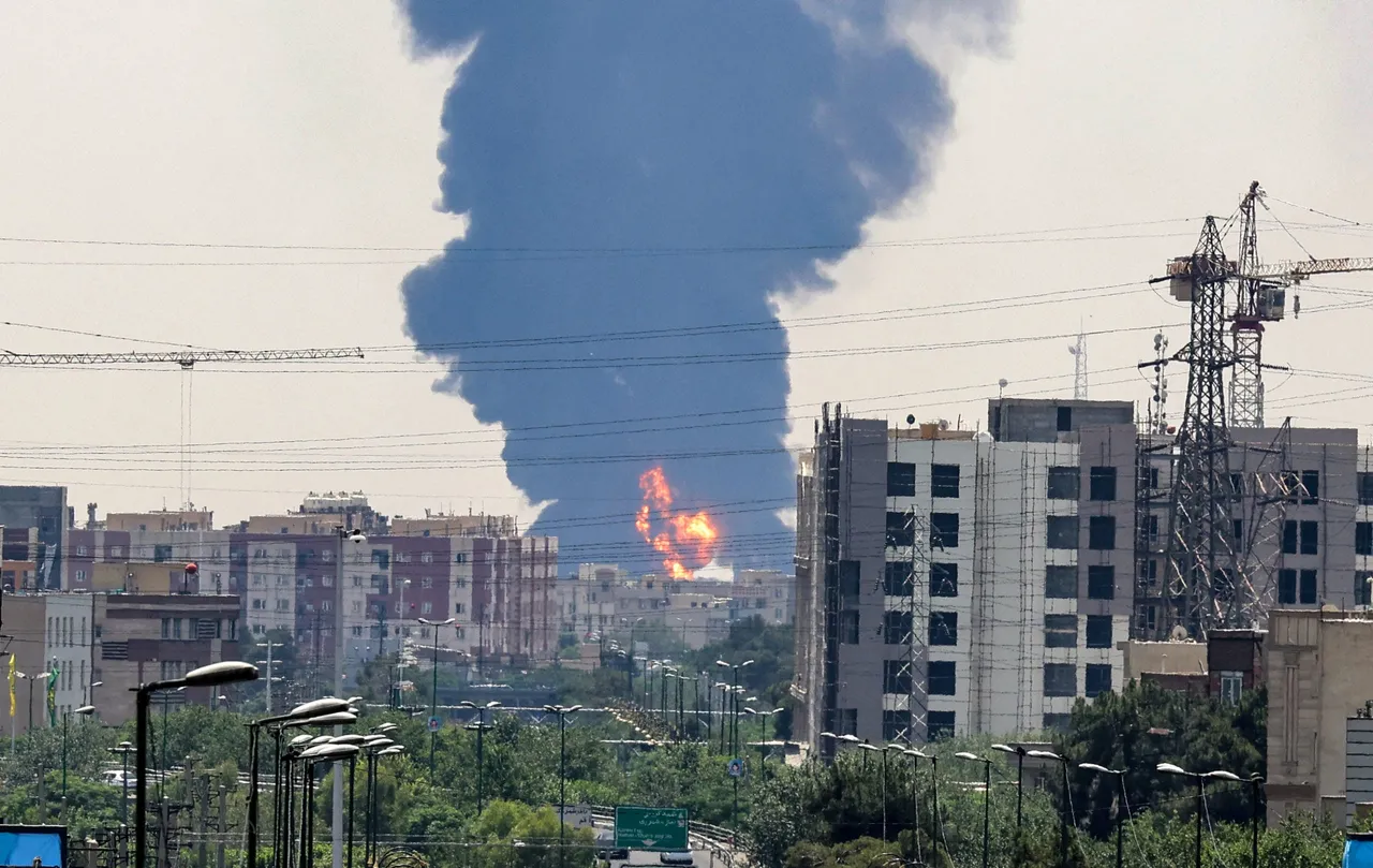 A plume of heavy smoke and fire rise over an oil refinery in southern Tehran, after it was hit in an overnight Israeli strike, on June 15, 2025. (Photo by ATTA KENARE/AFP via Getty Images)