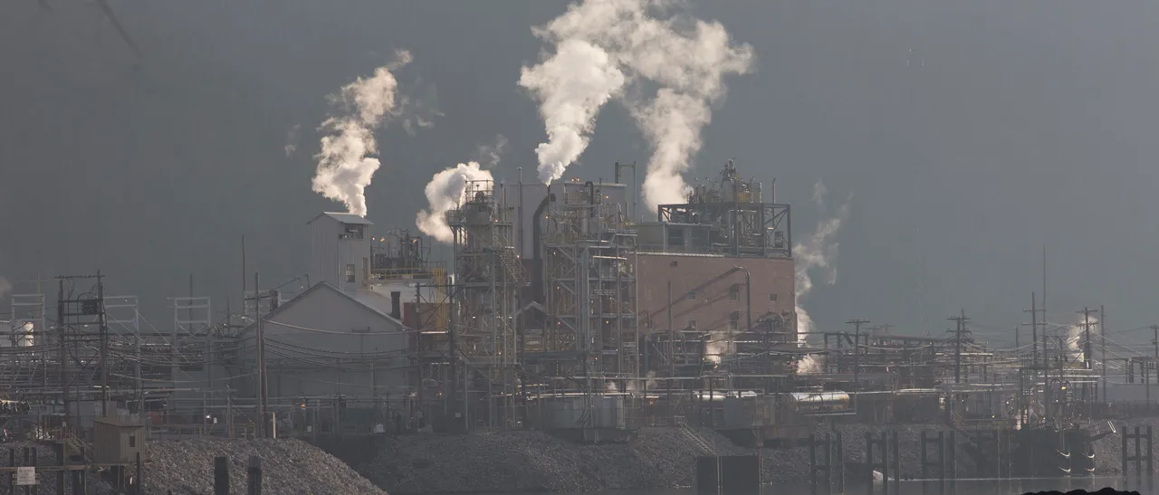 Just south of Charleston a coal barge travels up the Kanawha River, passing the Dupont chemical plant. (Photo by Andrew Lichtenstein/Corbis via Getty Images)