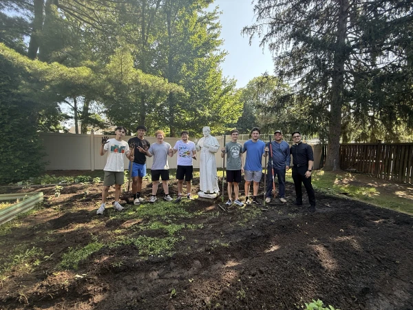 Father Matthew Gonzalez (far right) takes part in community service with members from the Sons of Thunder vocations club. Credit: Courtesy of Father Matthew Gonzalez
