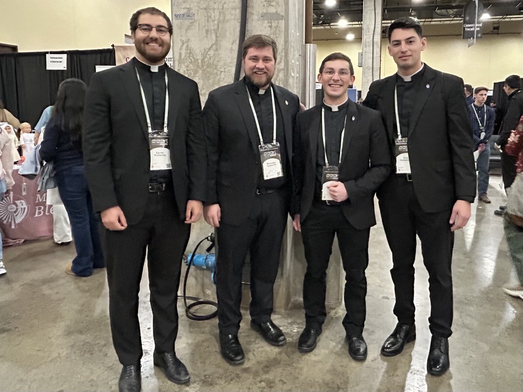 Seminarians (left to right) Xavier Polisetty, Nicholas Hoelscher, Lane Tschirhart, and Eric Hernandez explore the booths at Mission Way, an exhibition filled with information booths for Catholic ministries, religious orders, and vendors, at SEEK 2026 in Fort Worth, Texas, on Jan. 2, 2026. | Credit: Amira Abuzeid/CNA