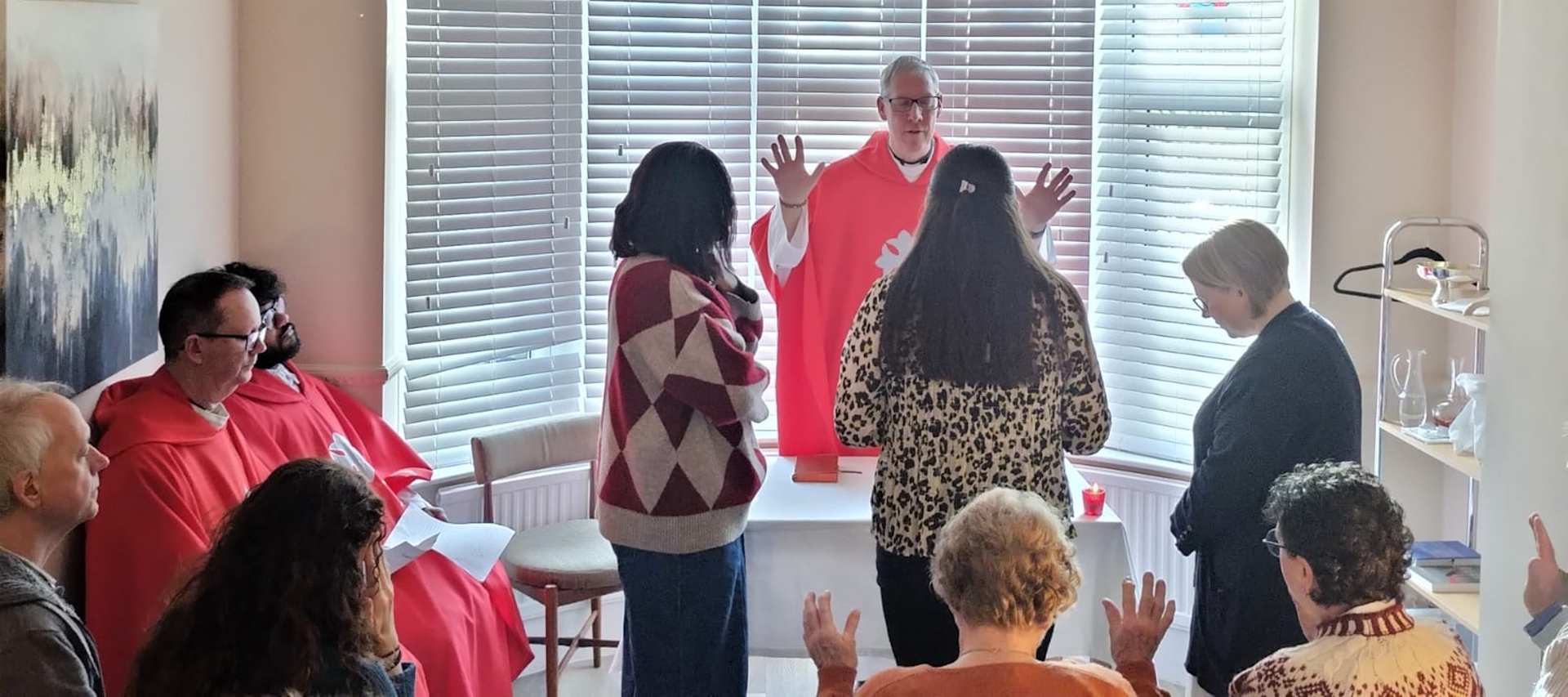 Northampton Episcopal Vicar for Mission Canon Simon Penhalagan prays for the new members of the new St. Elena House of Mission and Prayer in the new house in December 2025. | Credit: Maria Heath
