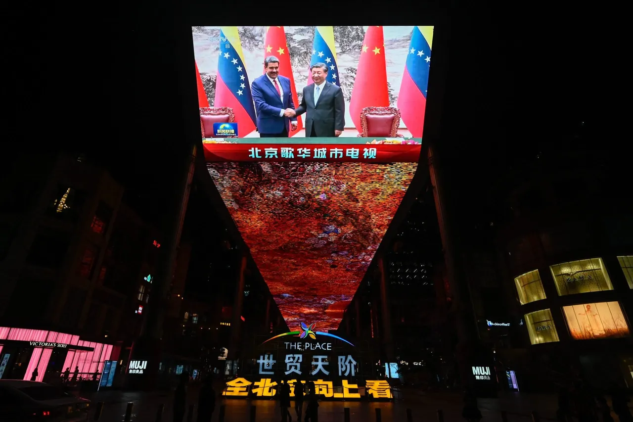 A giant screen outside a shopping mall shows news coverage of Venezuelan President Nicolas Maduro meeting Chinese President Xi Jinping in Beijing on September 13, 2023.