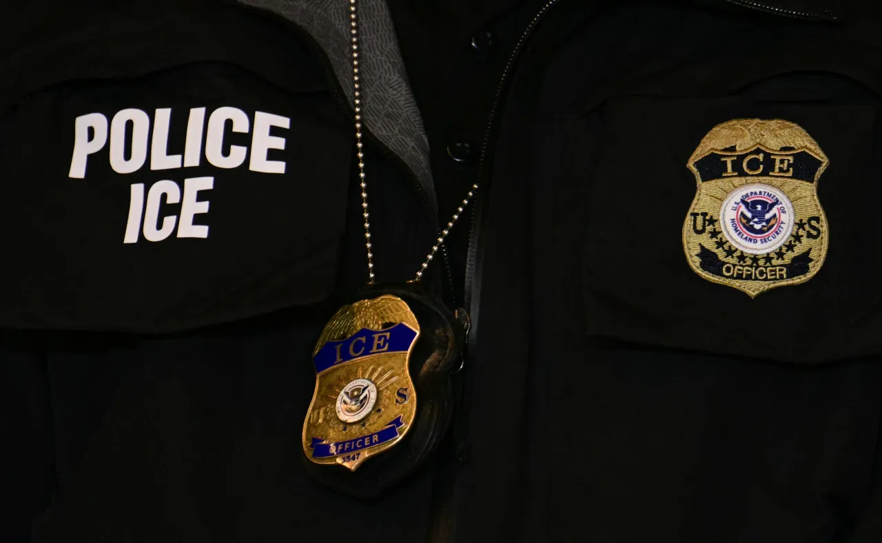MINNEAPOLIS, MINNESOTA - JANUARY 22: An ICE patch and badge are seen on a Department of Homeland Security agent while US Vice President JD Vance speaks U.S. Vice President JD Vance gives remarks following a roundtable discussion with local leaders and community members amid a surge of federal immigration authorities in the area, at Royalston Square on January 22, 2026 in Minneapolis, Minnesota. The Trump administration has sent a reported 3,000-plus federal agents into the area, with more on the way, as they make a push to arrest undocumented immigrants in the region. (Photo by Jim Watson - Pool/Getty Images)