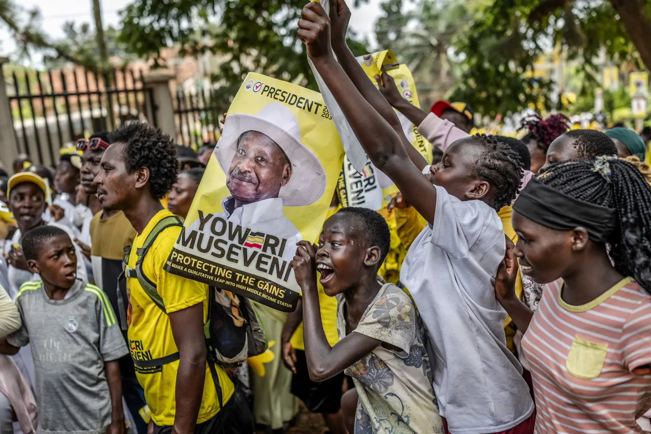 Young supporters of Uganda's incumbent president and National Resistance Movement (NRM) presidential candidate Yoweri Museveni hold electoral posters and chant slogans as they queue to enter the rally grounds ahead of the party's closing campaign rally ahead of the 2026 Ugandan general elections, in Kampala on January 13, 2026. (Photo by AFP via Getty Images)