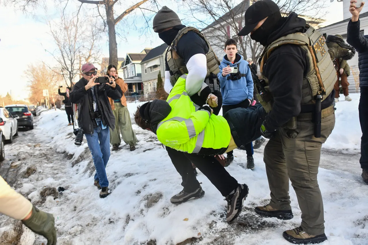 ICE and other federal officers detain a person during protests as ICE operates in a residential neighborhood in Minneapolis, Minnesota, on January 13, 2026. (Photo by Octavio Jones/AFP via Getty Images)