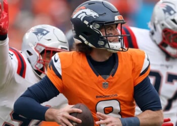 Broncos Fan Laid Out Like Blanket By Patriots Supporter In Post-Game Mile High Brawl