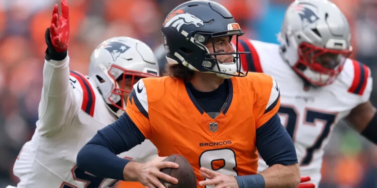 Broncos Fan Laid Out Like Blanket By Patriots Supporter In Post-Game Mile High Brawl
