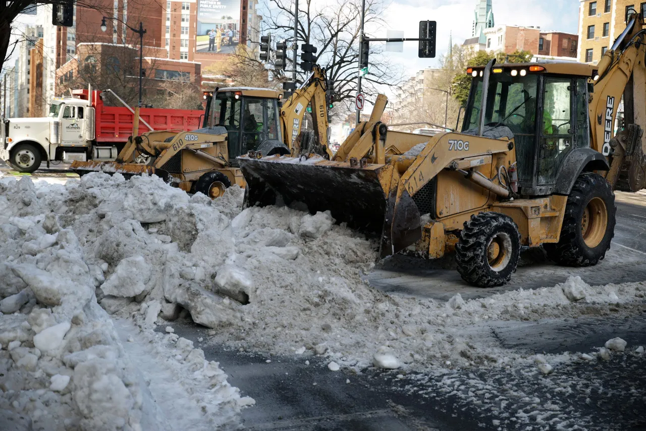 WASHINGTON, DC - JANUARY 29: Backhoe loaders remove snow left from the weekend snowstorm on Massachusetts Avenue on January 29, 2026 in Washington, DC. (Photo by Alex Wong/Getty Images)