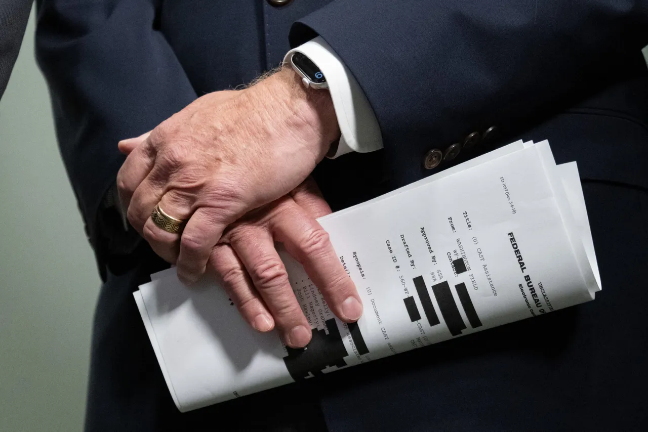 US Senator Ron Johnson, Republican of Wisconsin, holds a copy of an FBI document as he announces that an FBI whistleblower says the FBI during the Arctic Frost investigation had subpoenaed the records of Republican elected officials in Congress, during a press conference on Capitol Hill in Washington, DC, October 6, 2025. (Photo by SAUL LOEB/AFP via Getty Images)