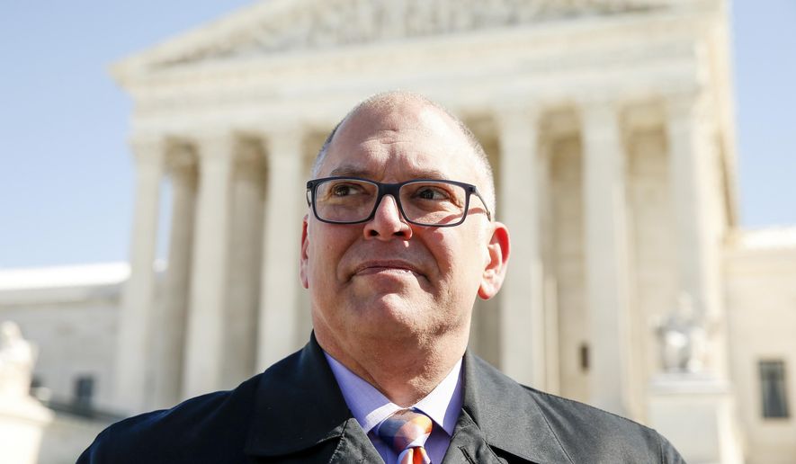 James Obergefell of the Human Rights Campaign speaks to a journalist as the campaign delivers copies of the "People's Brief," calling for full nationwide marriage equality, in Washington, March 6, 2015. (AP Photo/Andrew Harnik, File)