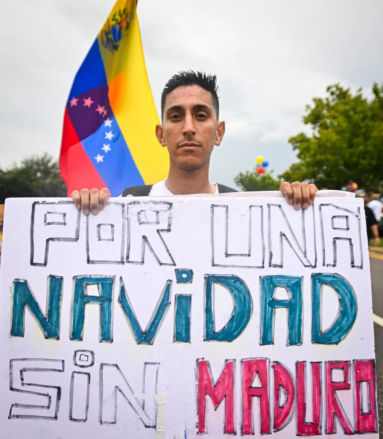 A demonstrator holds a banner that reads in Spanish 