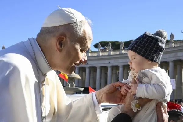 Pope Leo XIV blesses a newborn baby. Credit: Vatican Media