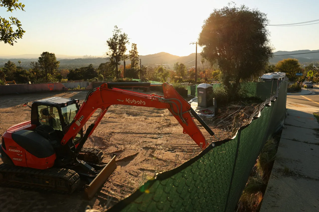 Construction equipment stands in the lots of a home under construction along East Loma Alta Drive in Altadena, California. (Photo by Patrick T. Fallon / AFP via Getty Images)