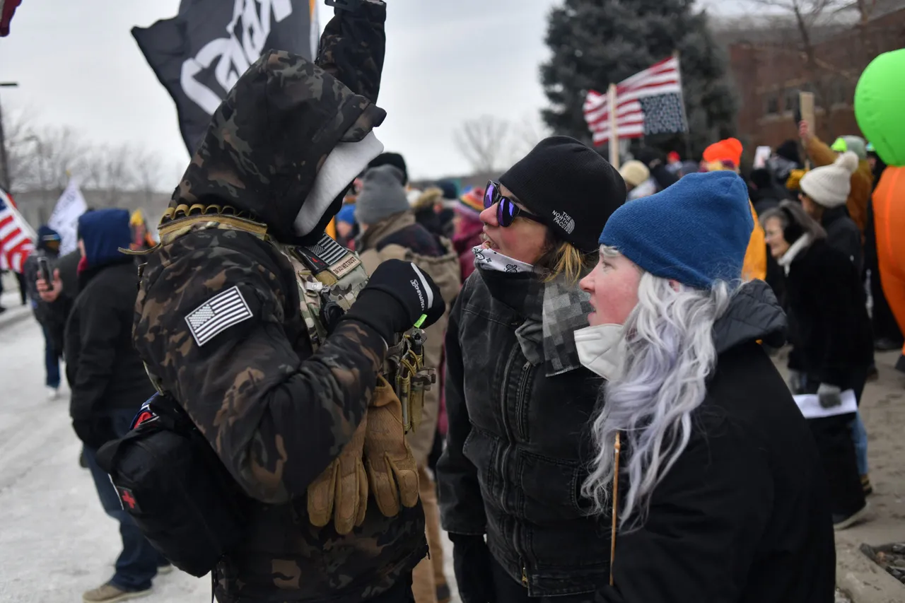 Protesters confronted by an ICE supporter during a demonstration outside the Bishop Whipple Federal Building in Minneapolis, Minnesota. (Photo by Octavio JONES / AFP via Getty Images)