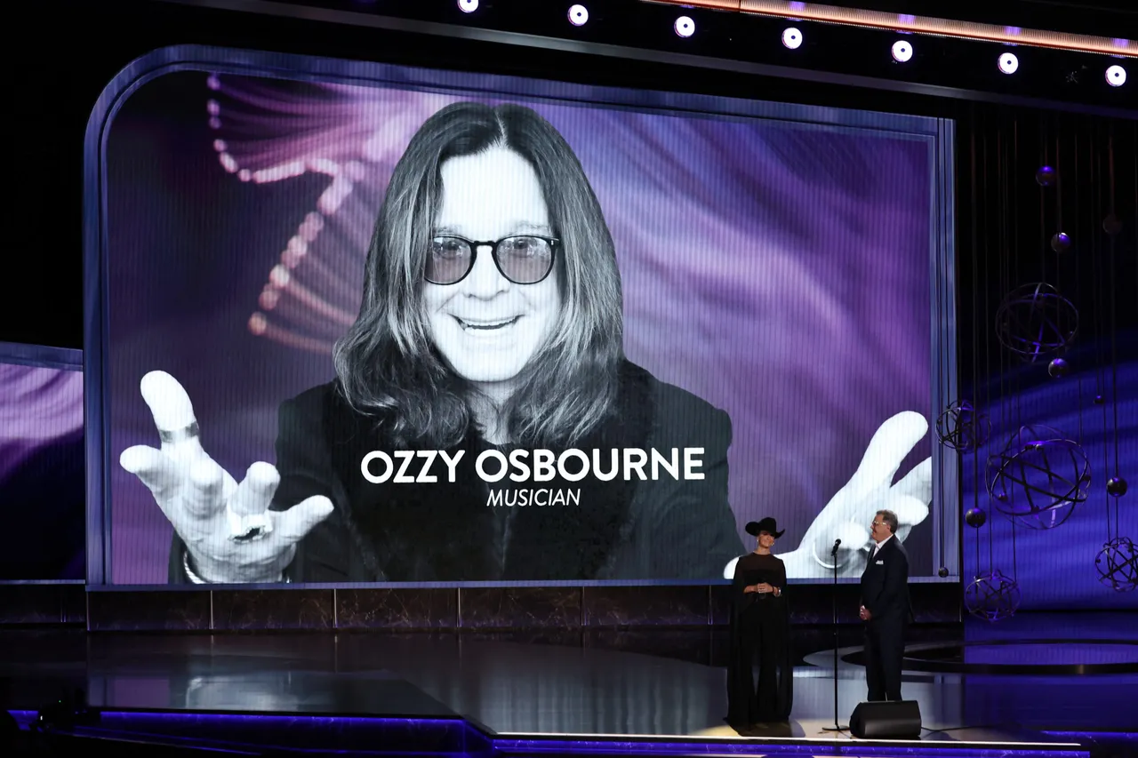 A picture of Ozzy Osbourne is seen on screen as US singer-songwriters Vince Gill and Lainey Wilson perform onstage during the 77th Primetime Emmy Awards at the Peacock Theatre at LA Live in Los Angeles on September 14, 2025. (Photo by VALERIE MACON / AFP) / RESTRICTED TO EDITORIAL USE (Photo by VALERIE MACON/AFP via Getty Images)