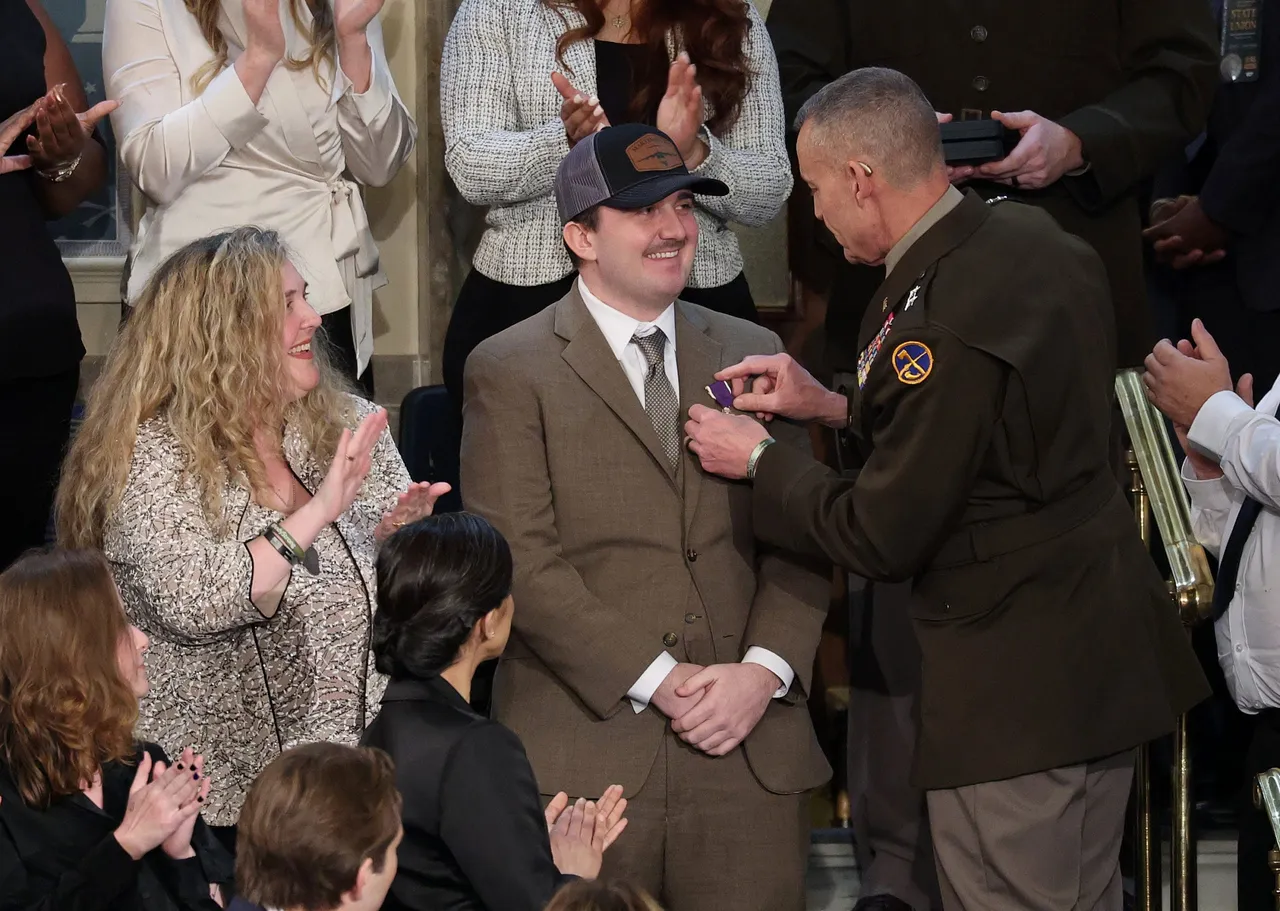 Air Force Staff Sgt. Andrew Wolfe receives a Purple Heart during U.S. President Donald Trump's State of the Union address during a Joint Session of Congress at the U.S. Capitol on February 24, 2026, in Washington, DC. Trump delivered his address days after the Supreme Court struck down the administration's tariff strategy and amid a U.S. military buildup in the Persian Gulf threatening Iran. (Photo by Win McNamee/Getty Images)