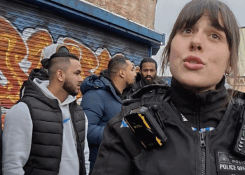 At last, a police officer defends a Christian preacher from a Muslim crowd