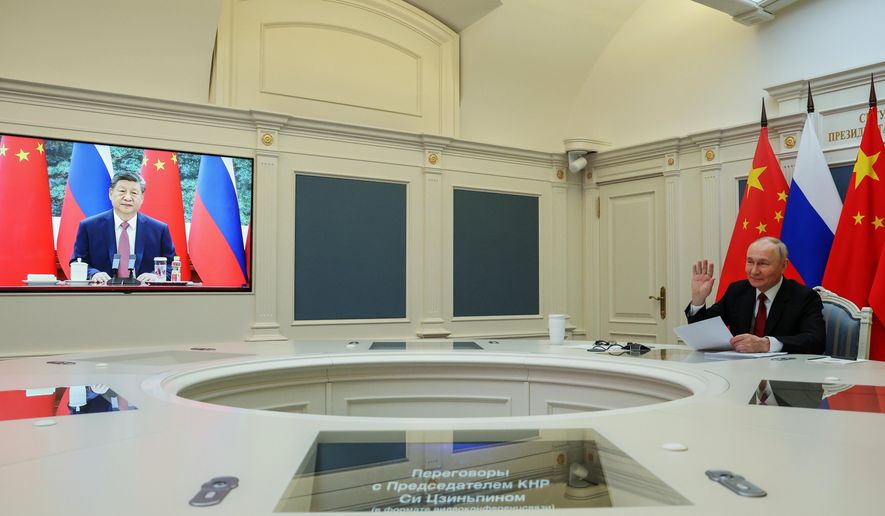 Russian President Vladimir Putin speaks with Chinese President Xi Jinping via videoconference at the Kremlin in Moscow, Wednesday, Feb. 4, 2026. (Vyacheslav Prokofyev/Sputnik, Kremlin Pool Photo via AP)
