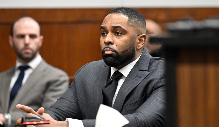 Former Michigan football coach Sherrone Moore, center, appears in the courtroom, Thursday, Jan. 22, 2026, in Ann Arbor, Mich. (AP Photo/Jose Juarez)