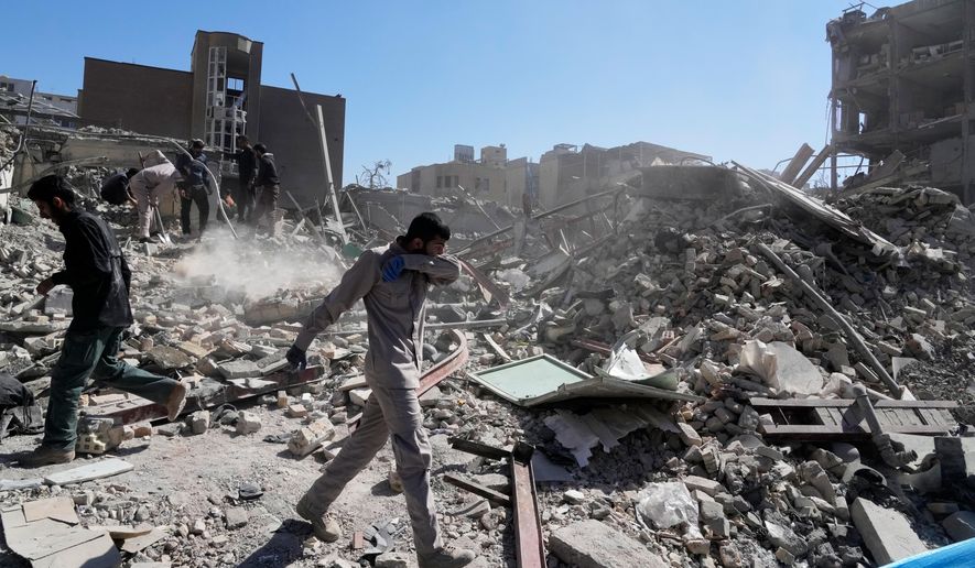 A group of men inspects the ruins of a police station struck Monday amid the U.S.–Israeli military campaign in Tehran, Iran, Tuesday, March 3, 2026. (AP Photo/Vahid Salemi)