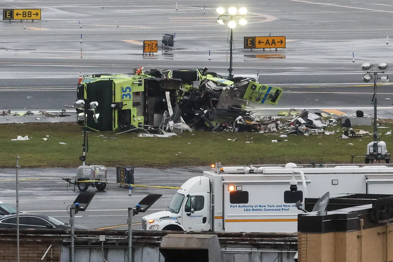 A damaged Port Authority fire truck sits near the runway after colliding with an Air Canada Express CRJ-900 at LaGuardia Airport in New York, on March 23, 2026. A plane carrying dozens of people collided with a fire truck on a runway at New York's LaGuardia airport, killing the pilot and co-pilot and causing "serious injuries" to others, authorities said Monday. Due to the crash late Sunday, US aviation authorities halted all flights at LaGuardia, and the port authority said the airport would stay shut until at least 2:00 pm (1800 GMT) "to allow for a thorough investigation." (Photo by TIMOTHY A. CLARY / AFP via Getty Images)