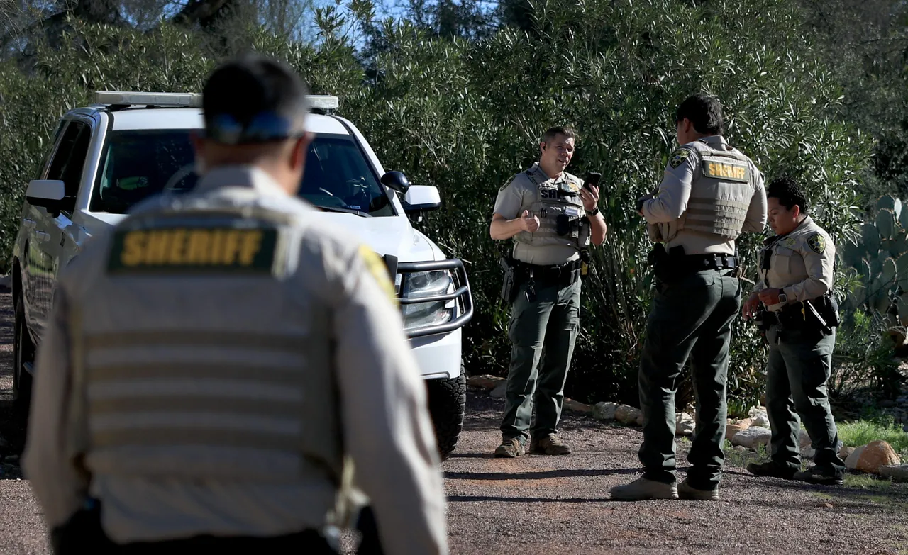 TUCSON, ARIZONA - FEBRUARY 22: Pima County Sheriff deputies stand in the driveway of Nancy Guthrie's home on February 22, 2026, in Tucson, Arizona. Law enforcement officials continue to search for Nancy Guthrie, the 84-year-old mother of U.S. journalist and television host Savannah Guthrie, after she went missing from her home on the morning of February 1st. (Photo by Joe Raedle/Getty Images)