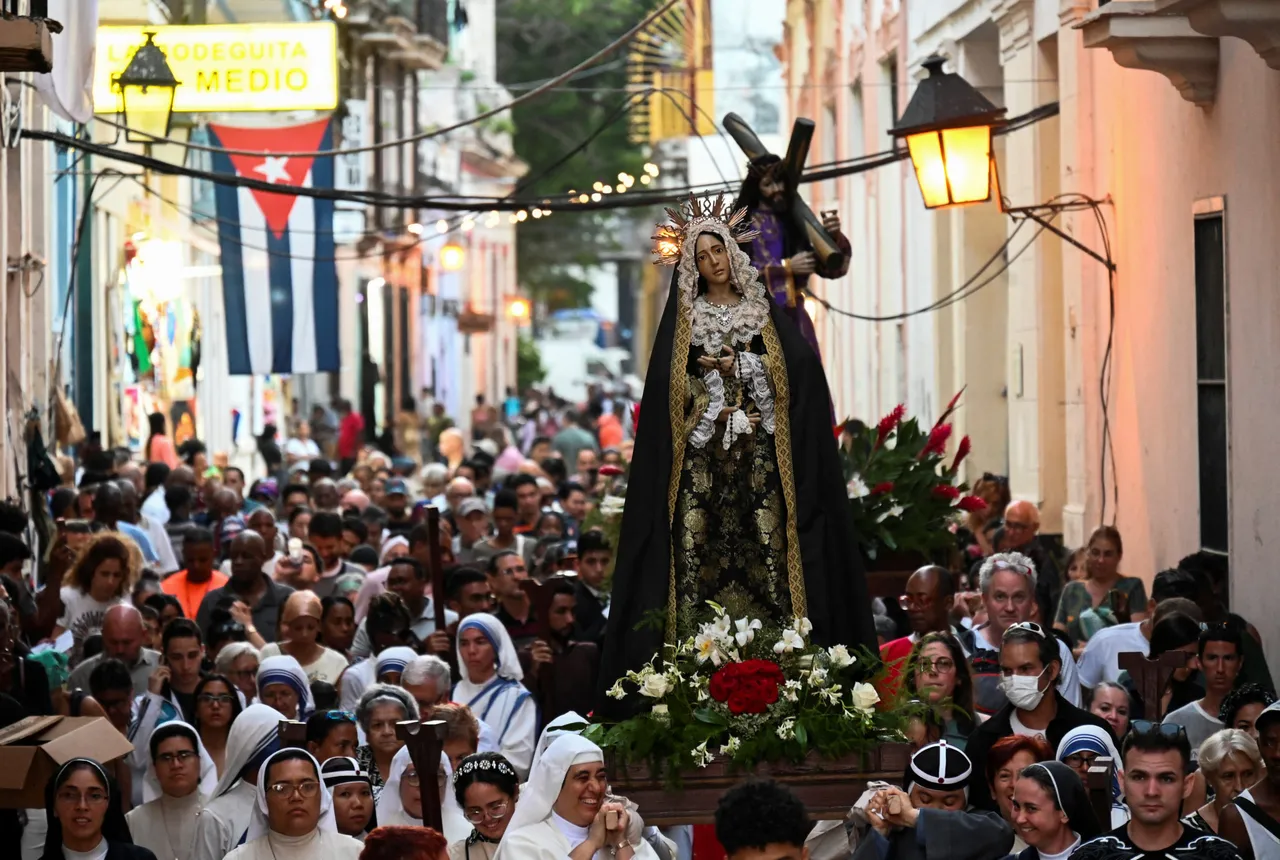TOPSHOT - Catholic faithful participate in the Good Friday Via Crucis procession along the streets of Havana on March 29, 2024. (Photo by YAMIL LAGE/AFP via Getty Images)