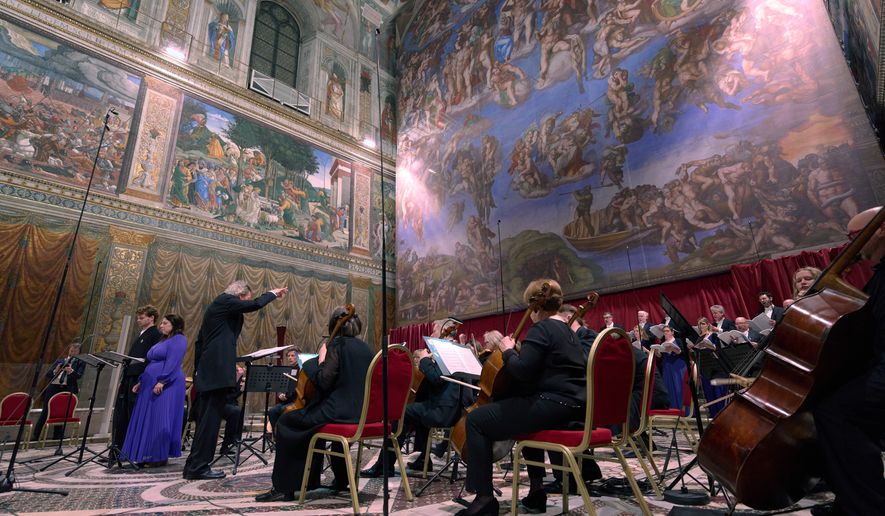 Tenor Matthew McKinney, left, and soprano Elizabeth Watts, second from left, sing Angels Unawares byJames MacMillan, conducted by Harry Christopher, third from left, in the Sistine Chapel at the Vatican, Sunday, March 22, 2026. (AP Photo/Domenico Stinellis)