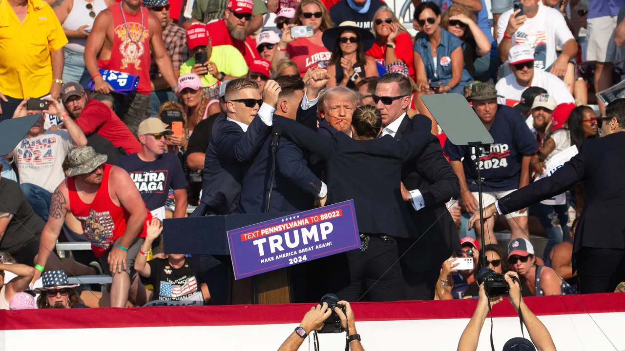 Republican candidate Donald Trump is seen with blood on his face surrounded by secret service agents as he is taken off the stage at a campaign event at Butler Farm Show Inc. in Butler, Pennsylvania, July 13, 2024. 