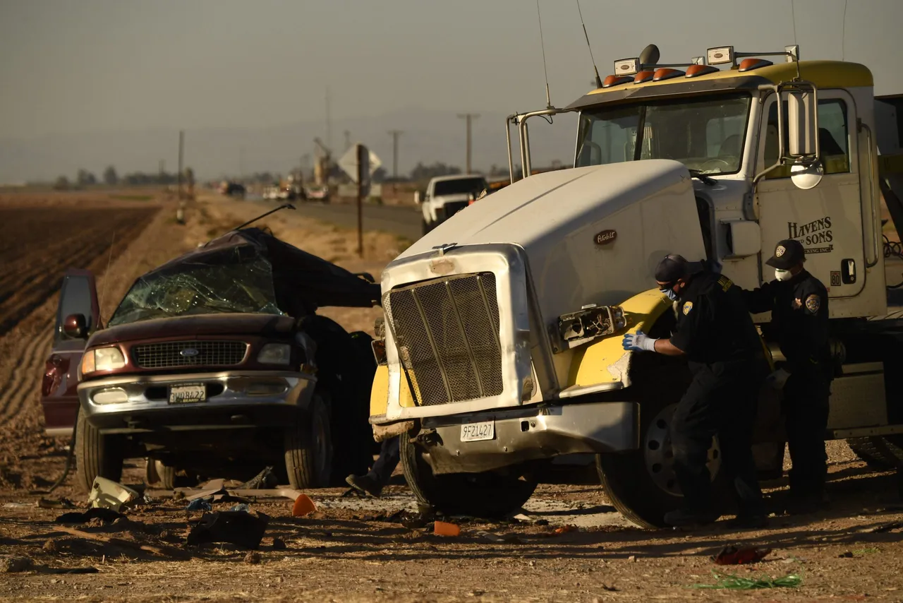 Investigators look over the scene of a crash between an SUV and a semi-truck full of gravel near Holtville, California on March 2, 2021. (Photo by Patrick T. FALLON / AFP) (Photo by PATRICK T. FALLON/AFP via Getty Images)
